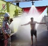 A man taking a shower after being contaminated.